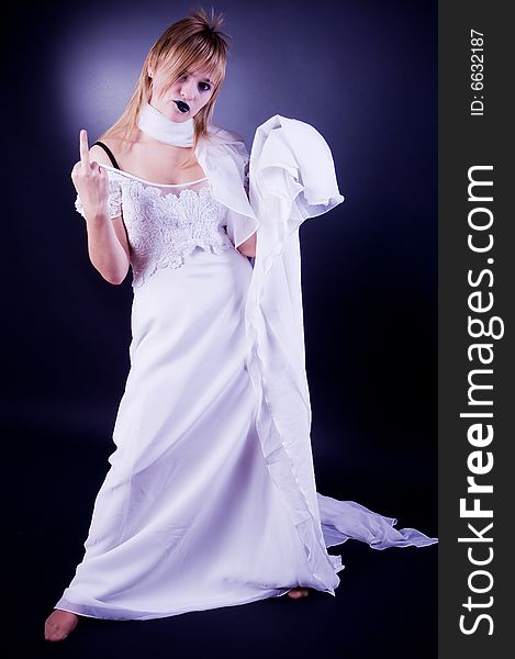 Young girl in wedding dress gesticulating, studio isolated