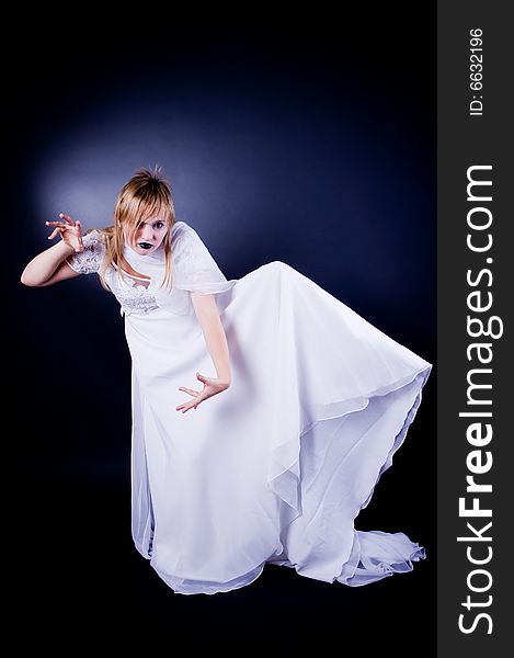 Expressive girl in wedding dress, studio isolated