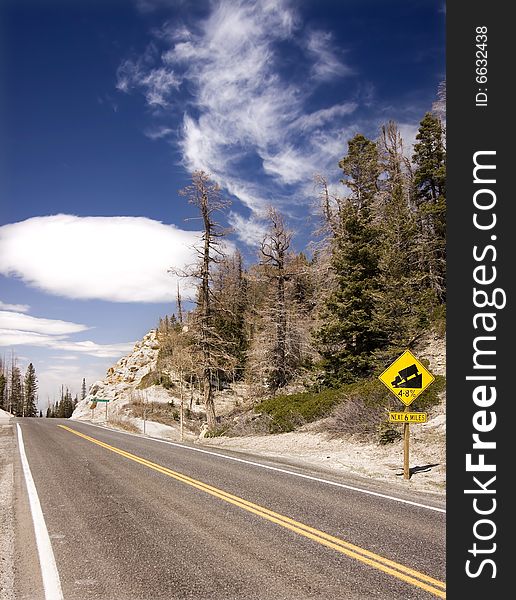 Mountain road with steep warning sign, Utah