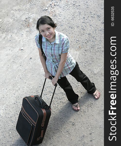 Traveler holding travel bag smiling. Traveler holding travel bag smiling