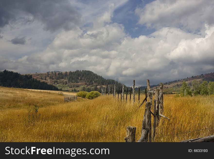 Farm in the mountains with a rain storm. Farm in the mountains with a rain storm