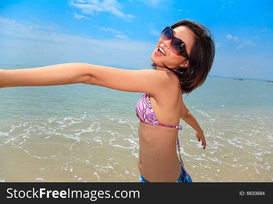 Asian young woman having fun at the beach