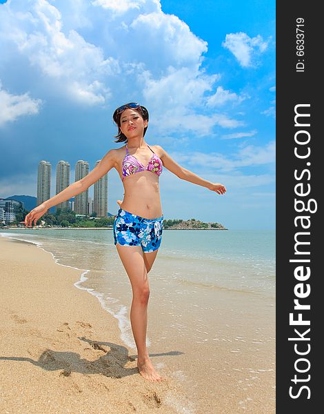 Asian young woman having fun at the beach