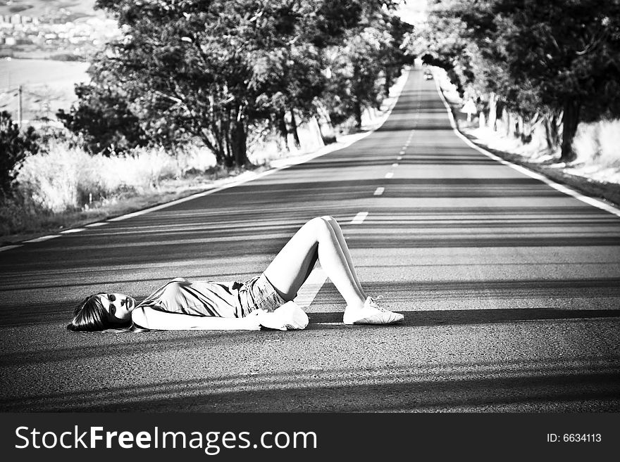 Young girl laying in the middle of nowhere. Young girl laying in the middle of nowhere.