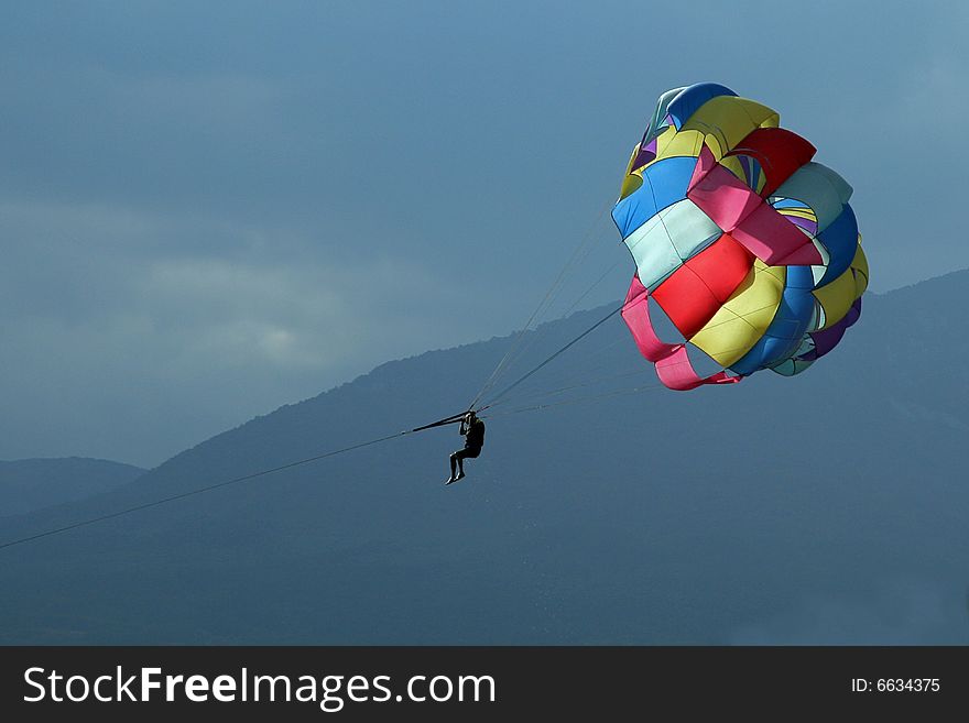 Multi-coloured parachute against the sky