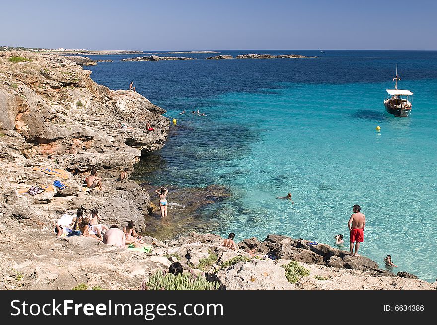 People at cliff shore swimming