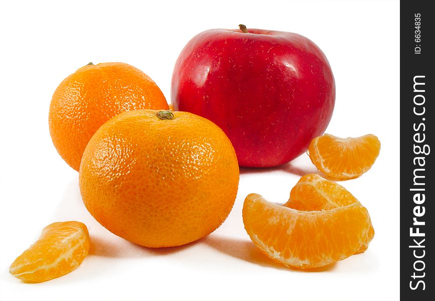 Mandarines and red apple on a white background. Mandarines and red apple on a white background