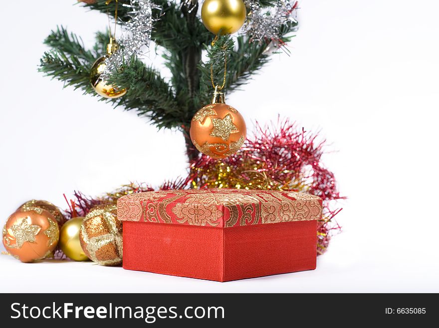 Present box under the Christmas tree isolated on a white background. Present box under the Christmas tree isolated on a white background.