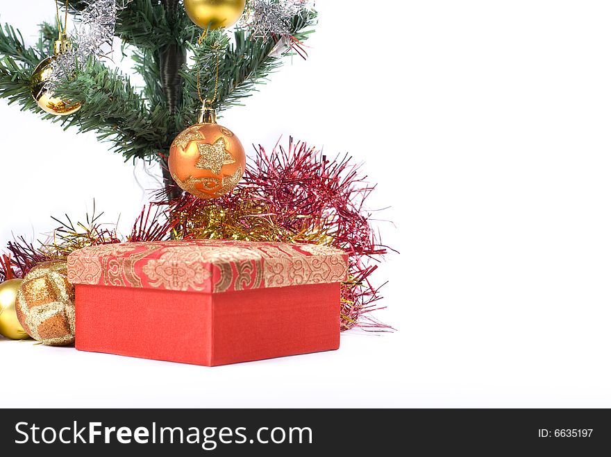 Present box under the Christmas tree isolated on a white background. Present box under the Christmas tree isolated on a white background.