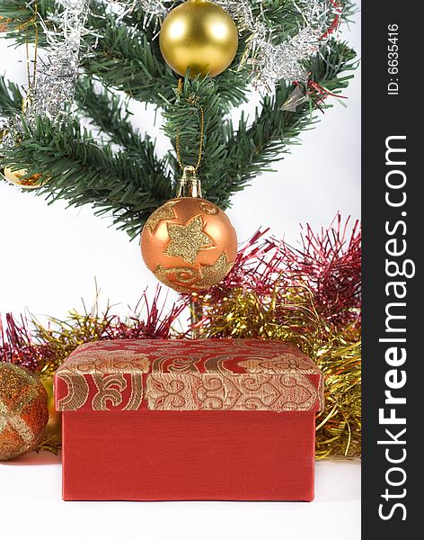 Present box under the Christmas tree isolated on a white background. Present box under the Christmas tree isolated on a white background.