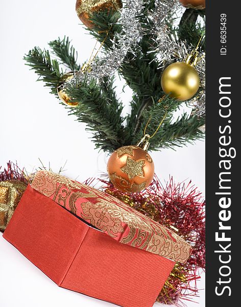 Present box under the Christmas tree isolated on a white background. Present box under the Christmas tree isolated on a white background.