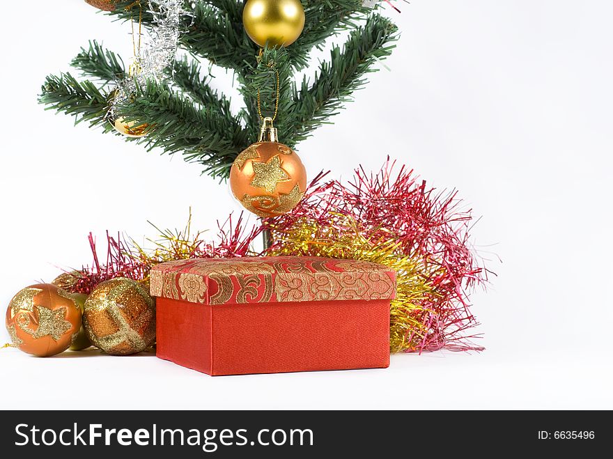 Present box under the Christmas tree isolated on a white background. Present box under the Christmas tree isolated on a white background.