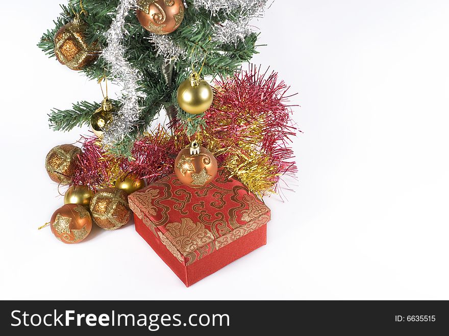 Present box under the Christmas tree isolated on a white background. Present box under the Christmas tree isolated on a white background.