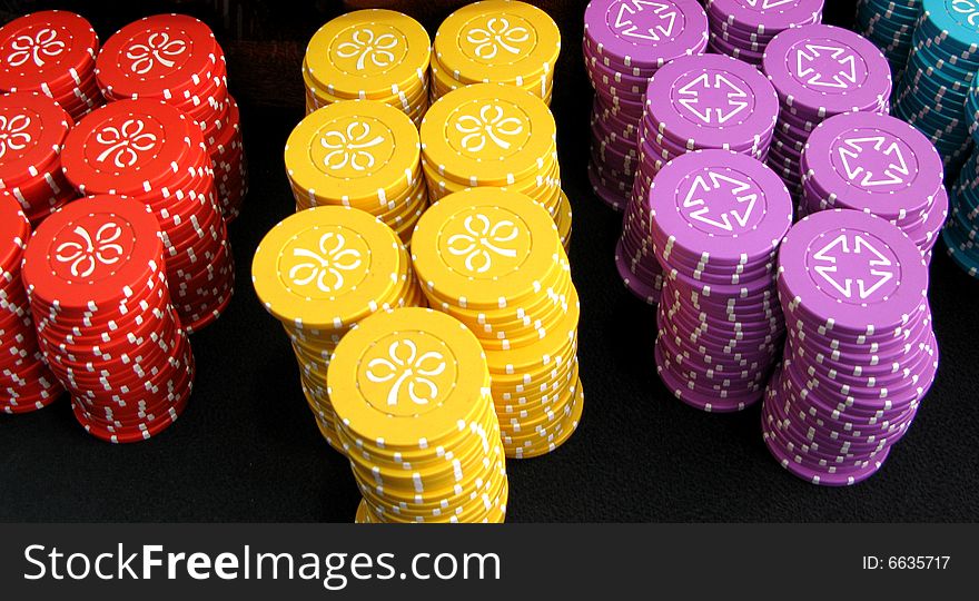 Coins on the casino - red, yellow, blue and violet. Coins on the casino - red, yellow, blue and violet