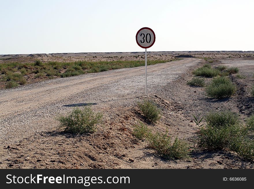 The Gobi is a large desert region in China and southern Mongolia measuring over 1600 kilometers from southwest to northeast and 800 km from north to south, which make it one of the largest deserts in the world and Asia's largest. gobi desert road ,30 Speed limit signs, dunhuang west china