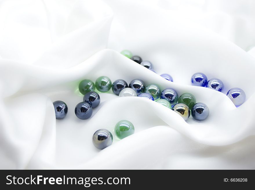 Glass balls on white silk