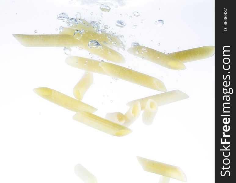 Macaroni preparing in water. Objects on white. Macaroni preparing in water. Objects on white