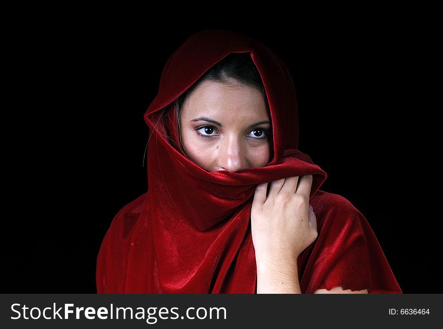 Beautiful young brunette woman in closeup with red shawl over face. Beautiful young brunette woman in closeup with red shawl over face