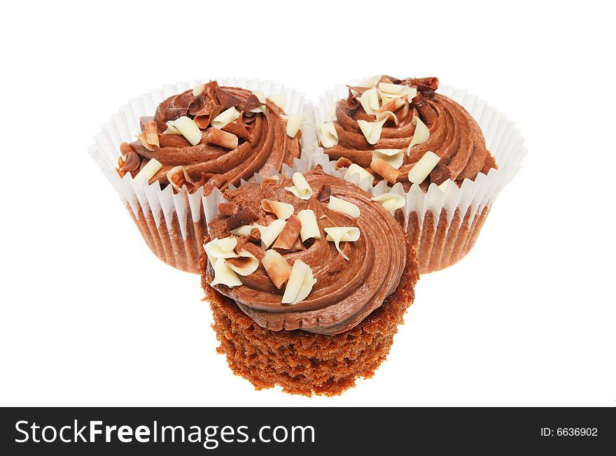 Three chocolate cup cakes isolated on white