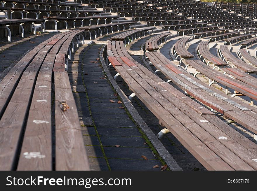 Empty wooden seats in a sports stadium