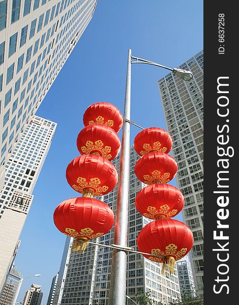 Red lantern and  skyscraper with blue sky in Beijing CBD(Central Business District),China. tradition   VS modern. Red lantern and  skyscraper with blue sky in Beijing CBD(Central Business District),China. tradition   VS modern