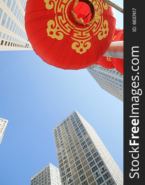 Red lantern and  skyscraper with blue sky in Beijing CBD(Central Business District),China. tradition   VS modern. Red lantern and  skyscraper with blue sky in Beijing CBD(Central Business District),China. tradition   VS modern