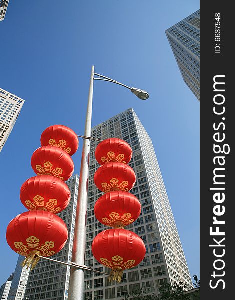 Red lantern and  skyscraper with blue sky in Beijing CBD(Central Business District),China. tradition   VS modern. Red lantern and  skyscraper with blue sky in Beijing CBD(Central Business District),China. tradition   VS modern