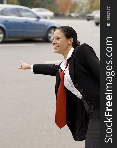 Portrait of pretty hitchhiking businesswoman