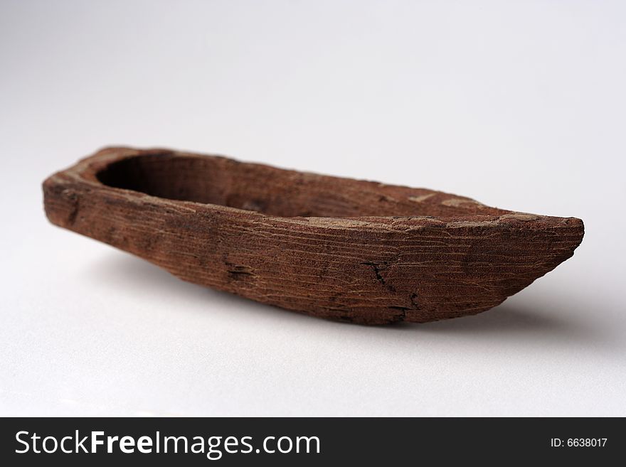 Little wooden boat on neutral background