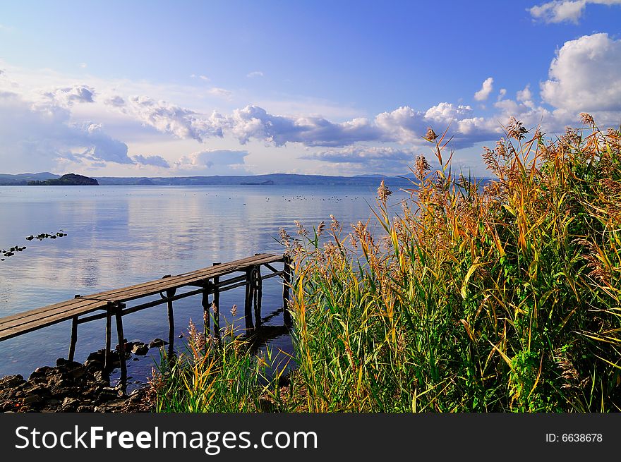 Lake view with bright sky, Typical plants and an harbor