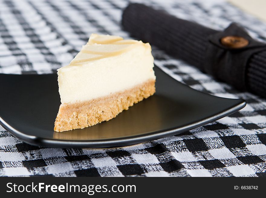 Delicious cheesecake on a black plate