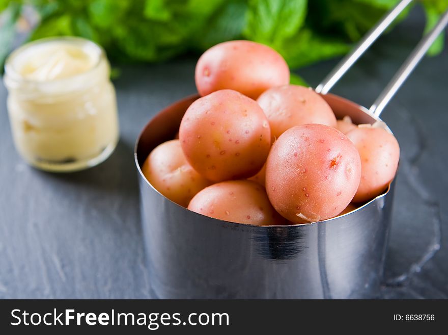 New potatoes in a small pan with butter