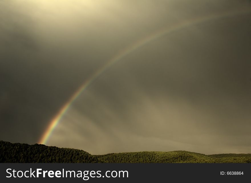 Rainbow in golden sky on sundown time. Rainbow in golden sky on sundown time