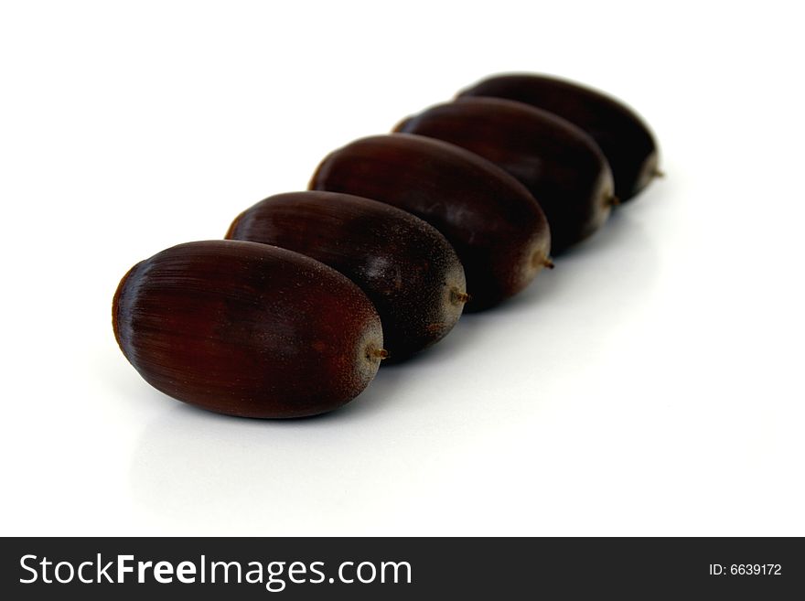 Five acorns lined up in a row taken with a shallow depth of field. Five acorns lined up in a row taken with a shallow depth of field