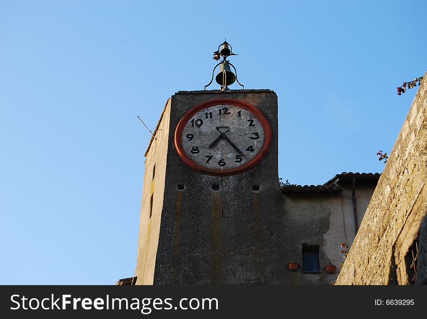 Ancient clock with bell in Orvieto, Italy