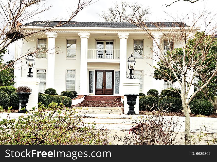 Stately antebellum mansion with big white columns taken in winter. Stately antebellum mansion with big white columns taken in winter