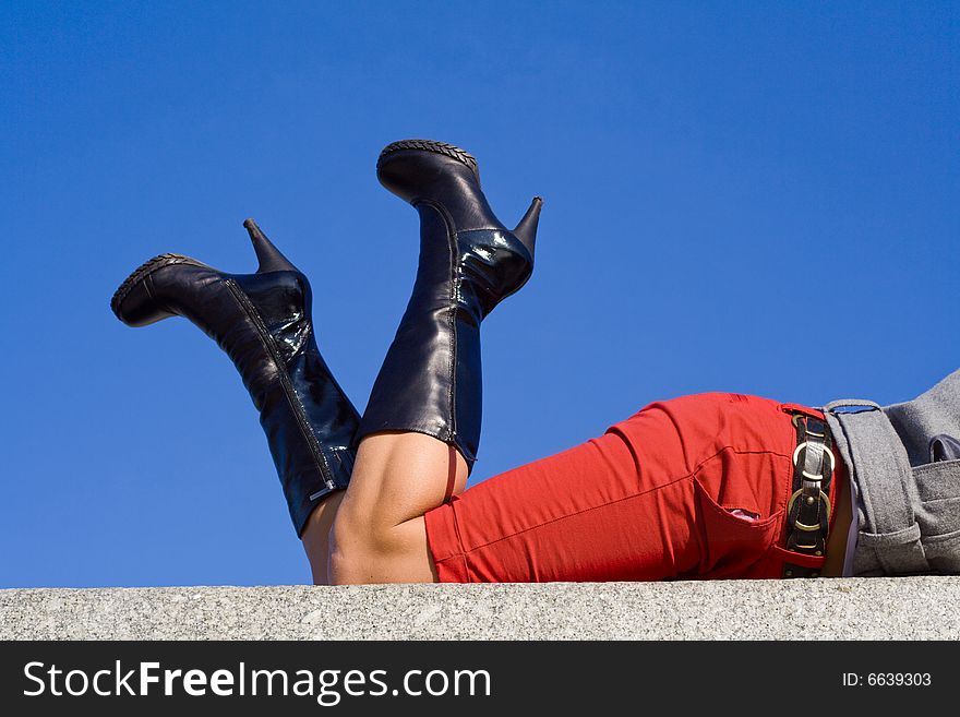Woman legs in long black boots on horizontal surface. Woman legs in long black boots on horizontal surface