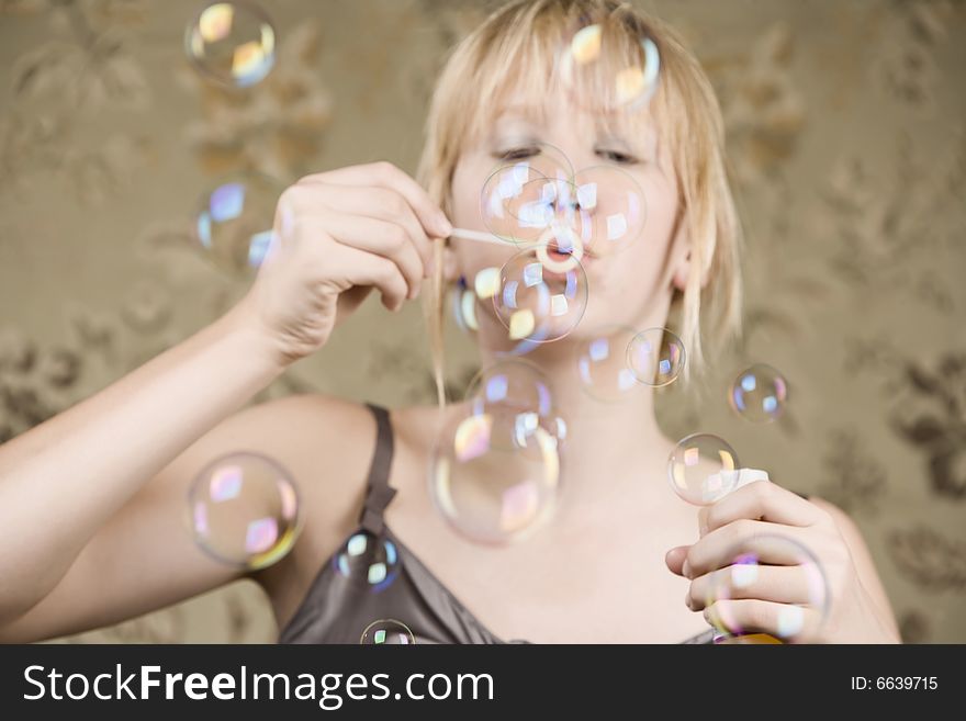 Pretty young girl with blue eyes blowing bubbles. Pretty young girl with blue eyes blowing bubbles