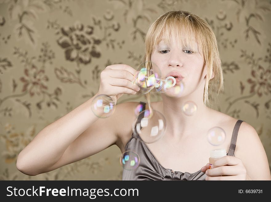 Pretty Young Girl Blowing Bubbles