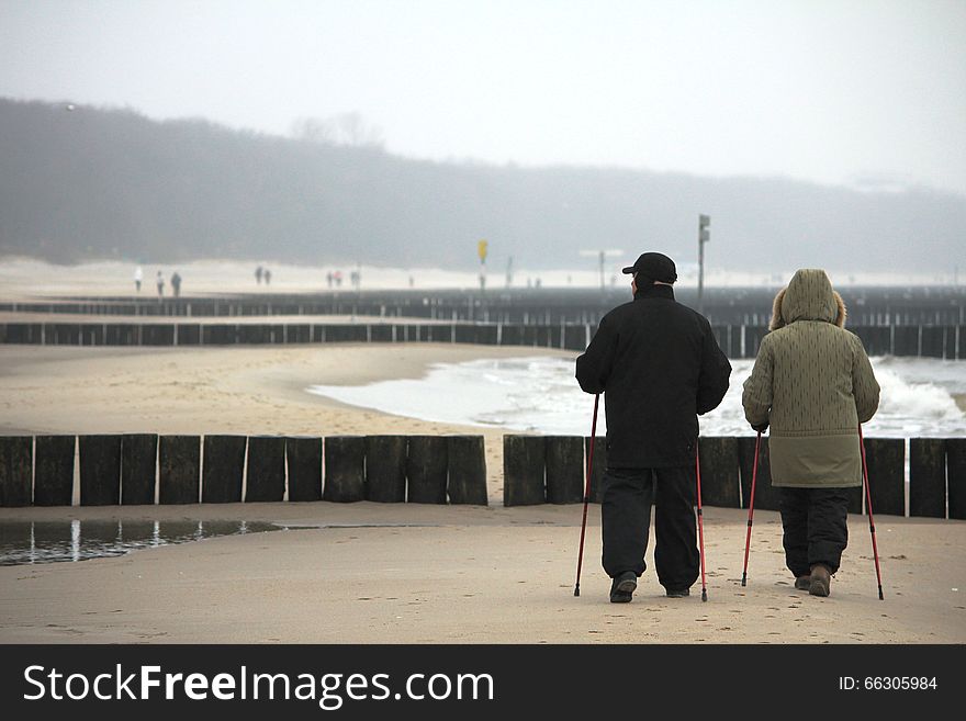 Photo made in the winter at the coast of Baltic Sea. Many people are walking despite the groomy weather. Nordic-walking is very popular among elder people. Photo made in the winter at the coast of Baltic Sea. Many people are walking despite the groomy weather. Nordic-walking is very popular among elder people.