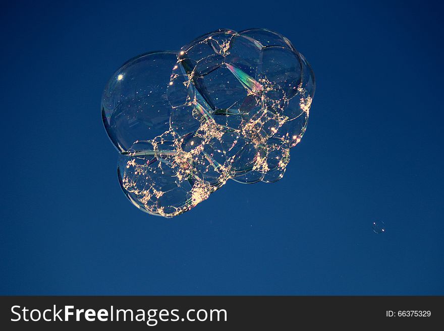 Shimmering floating bubble cluster with bokeh effect. Shimmering floating bubble cluster with bokeh effect