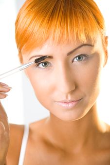 Red-haired Woman Making Her Makeup Stock Images Red-haired Woman Making Her Makeup Stock Images