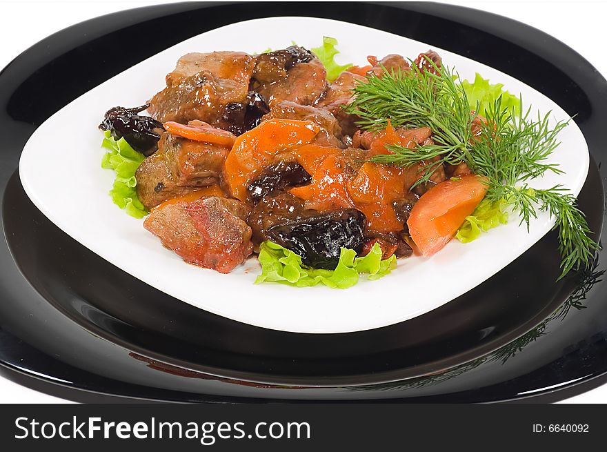 Meat of the rabbit on a black and white plates, isolated on white