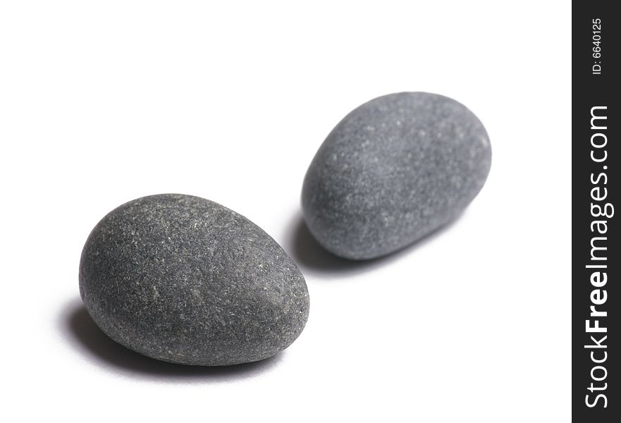 Two smooth stones on white background. Two smooth stones on white background