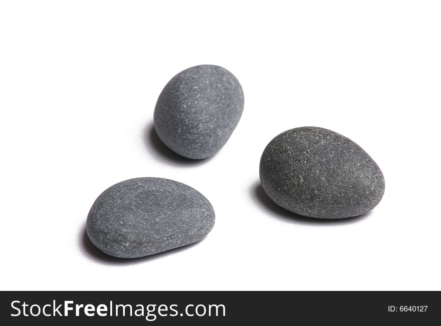 Three smooth stones on white background. Three smooth stones on white background