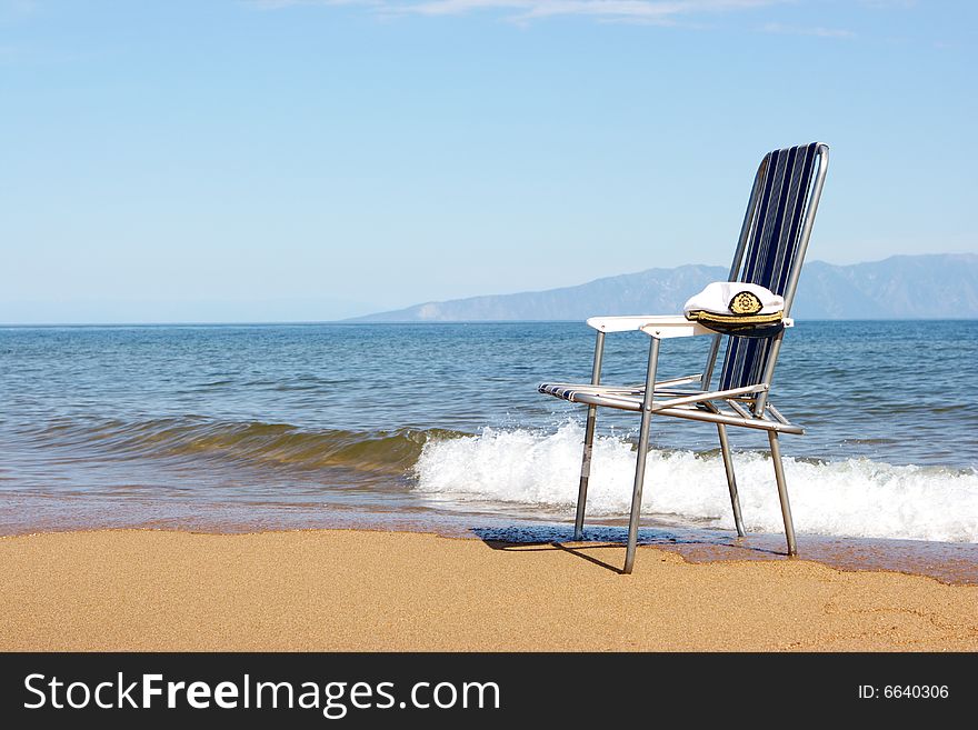 Lonely chair on seacoast with a place for the text