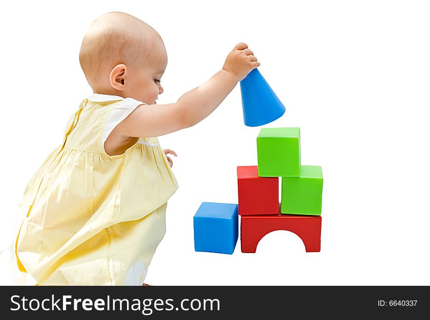 Little baby girl playing with her toys, isolated on white