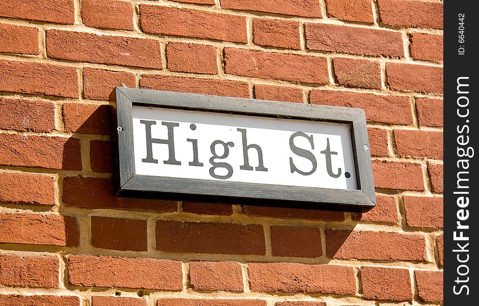 Ancient road sign showing High St in wooden frame. Ancient road sign showing High St in wooden frame