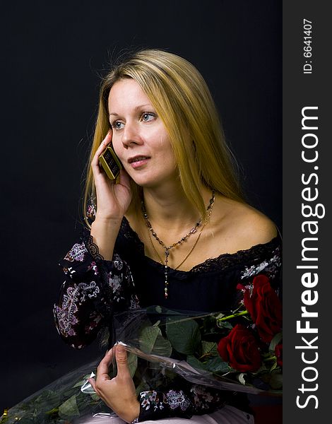 Long hair blonde woman with bunch of flowers and mobile phone. Long hair blonde woman with bunch of flowers and mobile phone