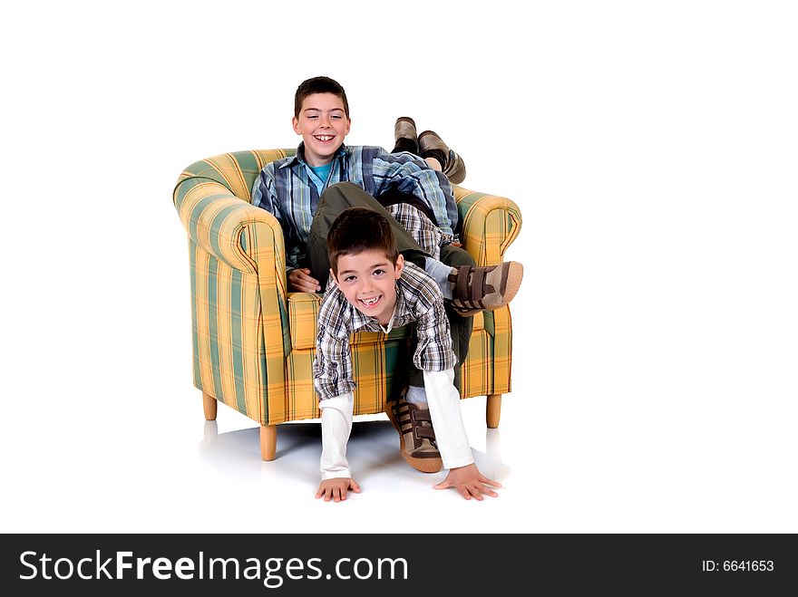 Two young happy smiling boys playing in the chair. Two young happy smiling boys playing in the chair